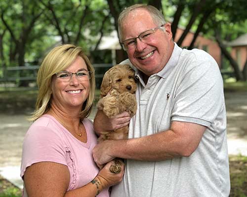 happy owner with apricot labradoodle