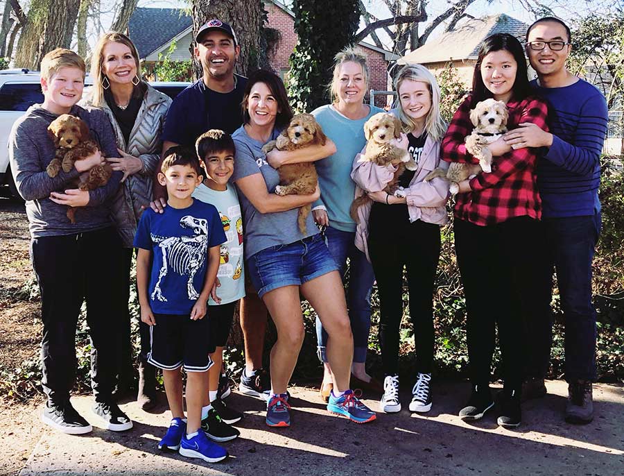 happy owners with labradoodles